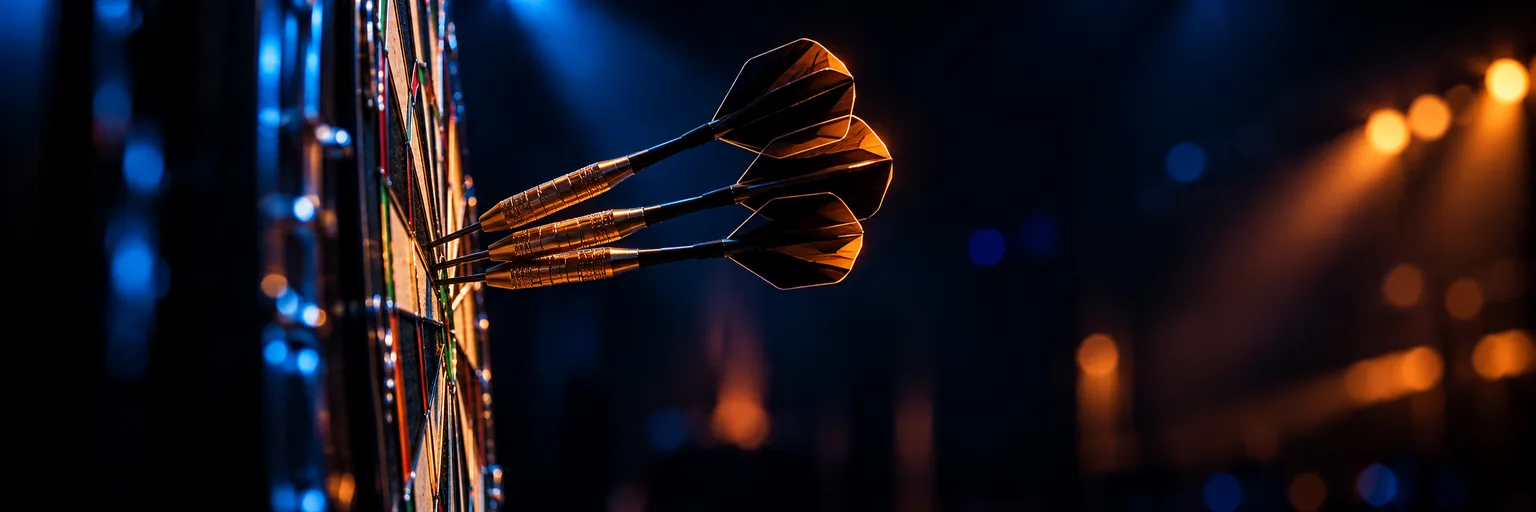 Side view of darts clustered in a board under hard rim light