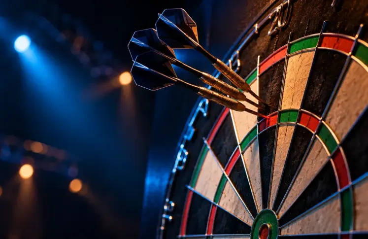 Tournament dartboard with three darts grouped in the treble twenty