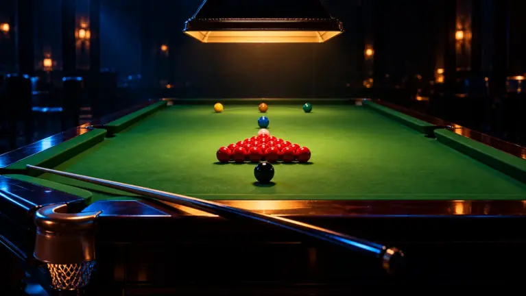 Snooker table under a low hanging lamp with the reds racked