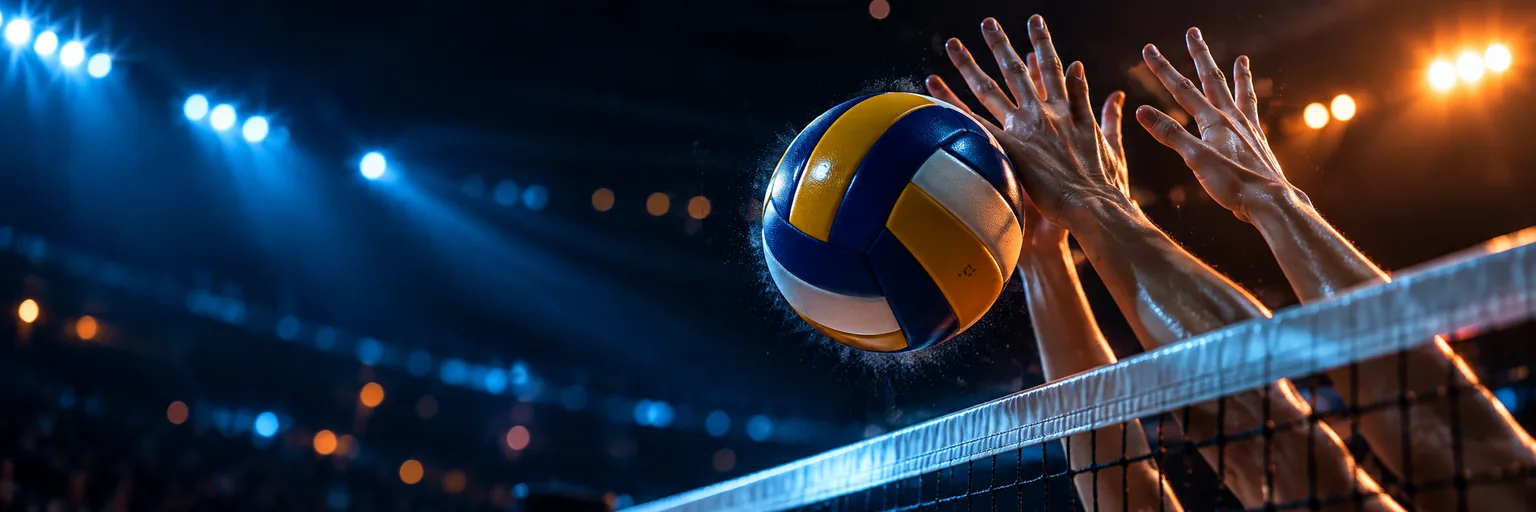Close up of a volleyball meeting two blockers hands above the net